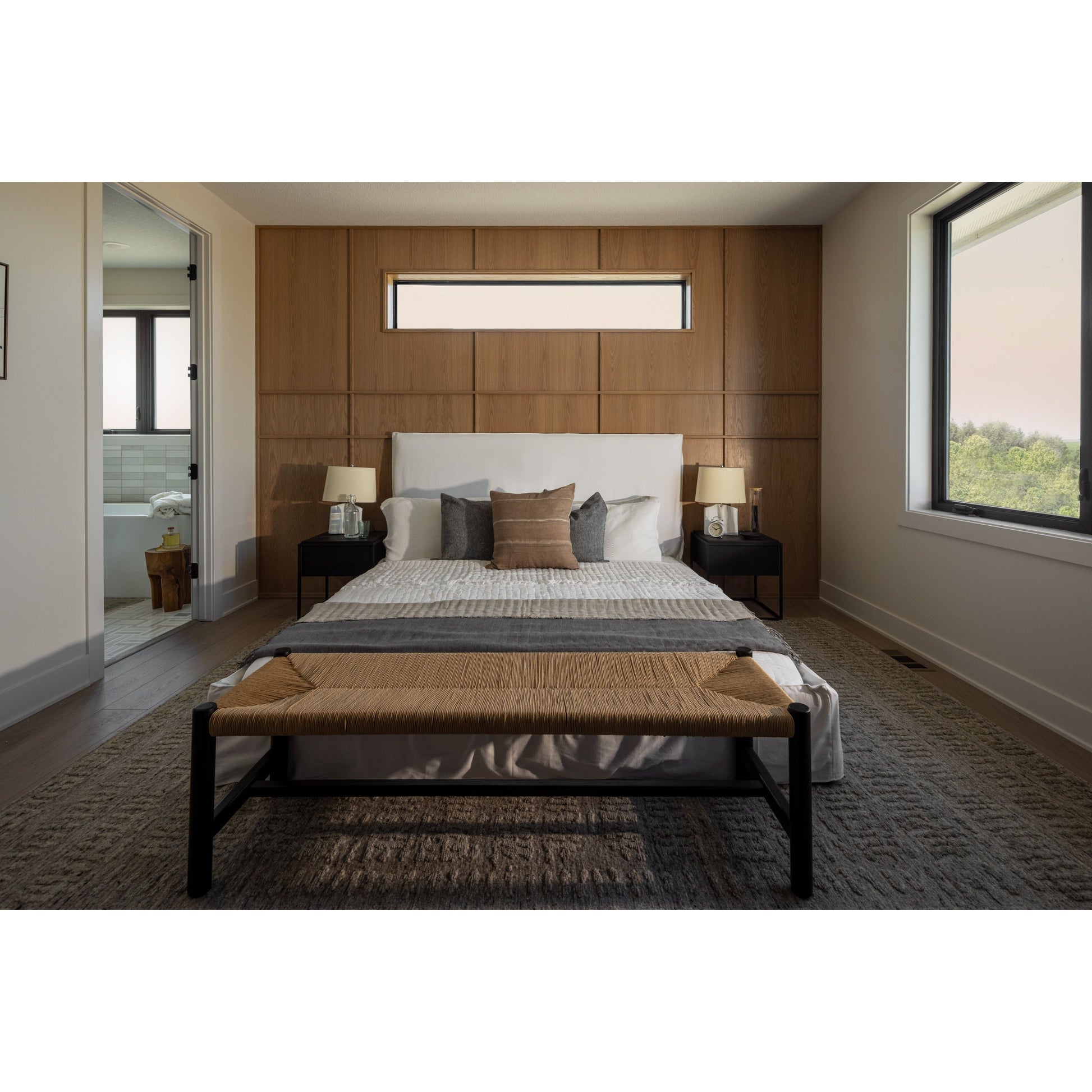 Cisco Brothers April Bed is designed and constructed in Los Angeles. The pinched edges and clean lines bring a modern, minimalist feel to any bedroom. Photographed in White Denim and Bengal Pin Striped Indigo. Amethyst Home provides interior design, new home construction design consulting, vintage area rugs, and lighting in the Charlotte metro area.