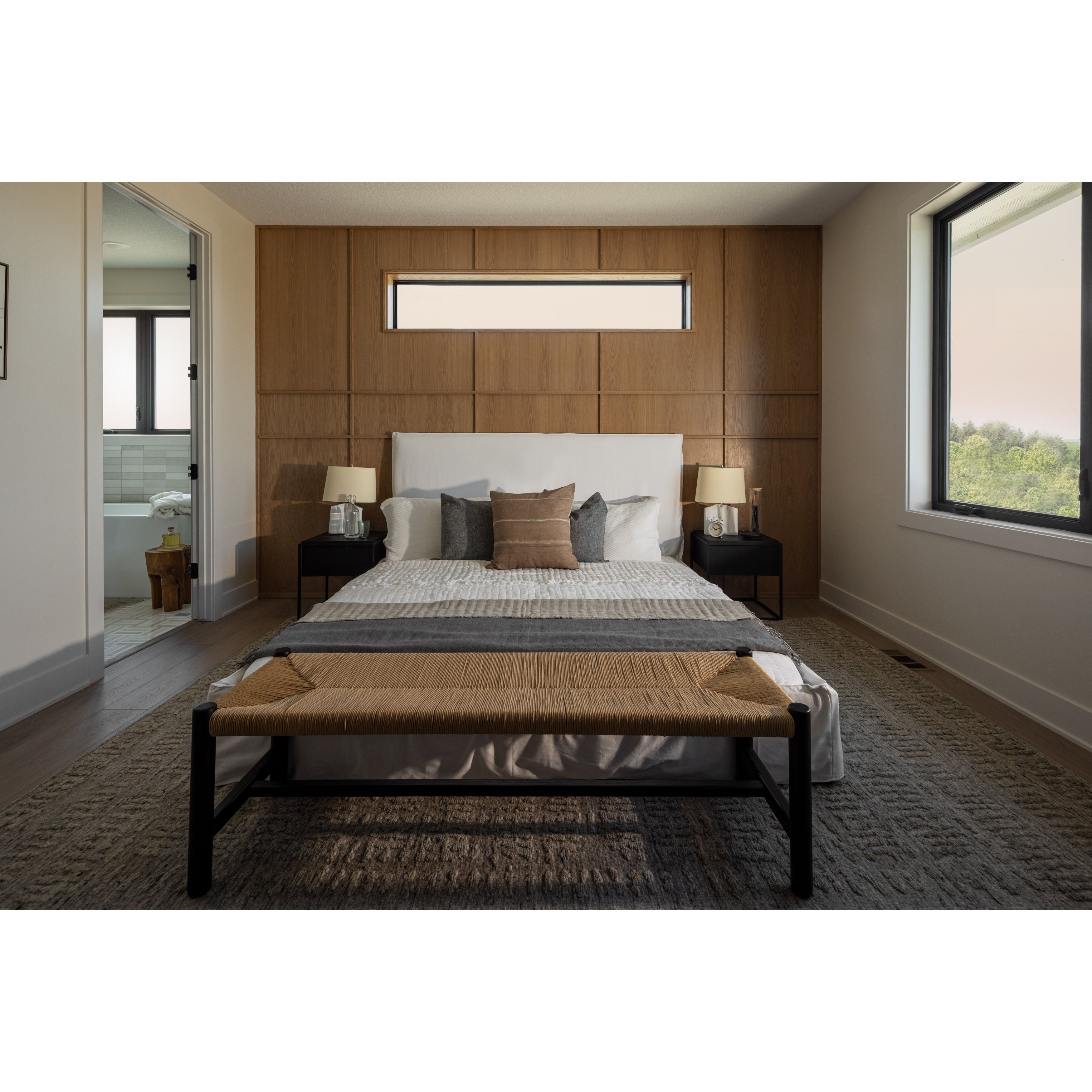 Cisco Brothers April Bed is designed and constructed in Los Angeles. The pinched edges and clean lines bring a modern, minimalist feel to any bedroom. Photographed in White Denim and Bengal Pin Striped Indigo. Amethyst Home provides interior design, new home construction design consulting, vintage area rugs, and lighting in the Charlotte metro area.