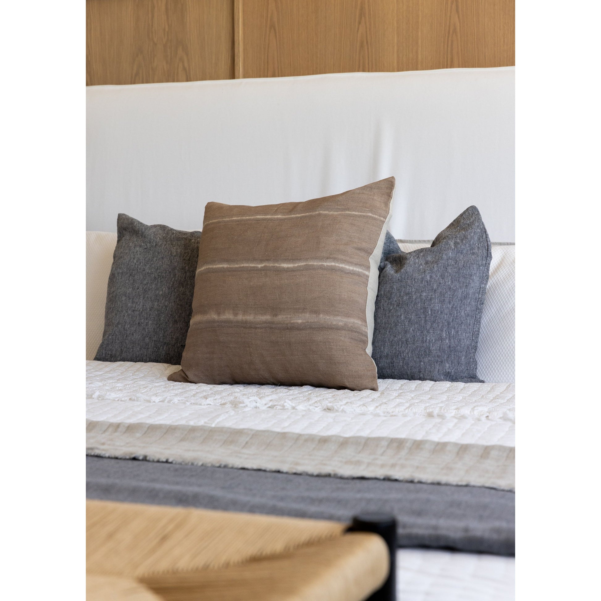 Cisco Brothers April Bed is designed and constructed in Los Angeles. The pinched edges and clean lines bring a modern, minimalist feel to any bedroom. Photographed in White Denim and Bengal Pin Striped Indigo. Amethyst Home provides interior design, new home construction design consulting, vintage area rugs, and lighting in the Austin metro area.