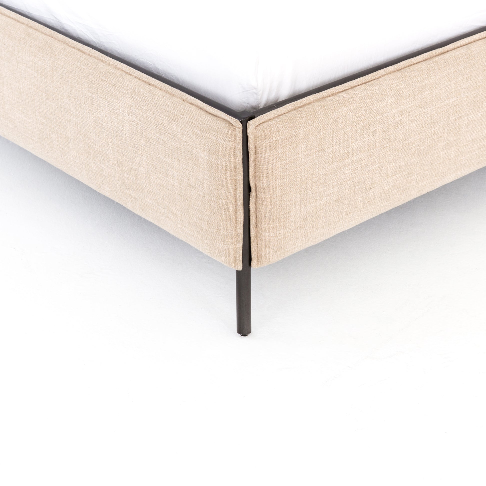 Safari styling gets a modern reboot with this Leigh Upholstered Bed. Linen-blend upholstery of neutral taupe lays a texture-rich base for a forward-thinking bedroom look. Brown leather straps secure decorative headboard pillows, suspended for eye-catching effect. Box spring required.