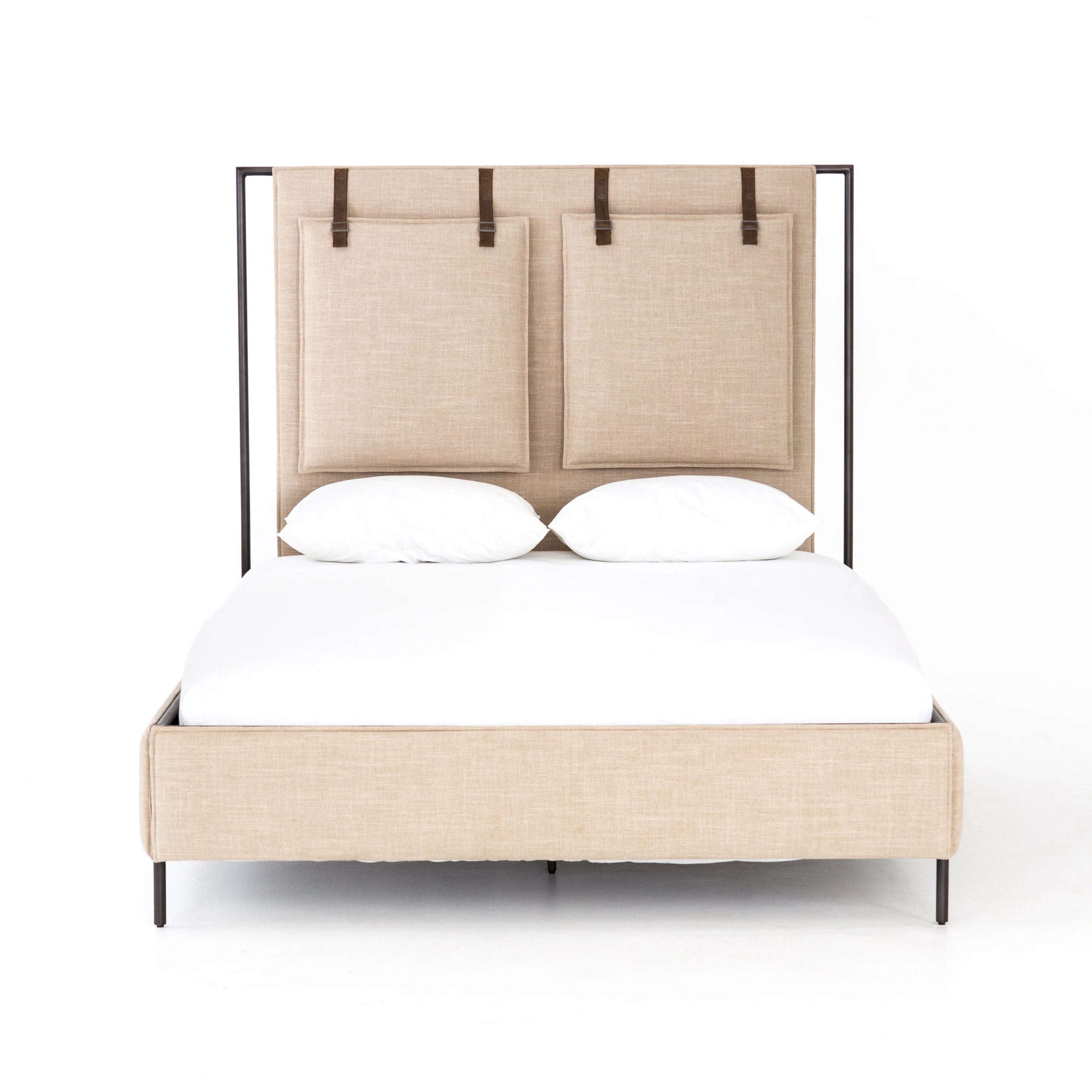 Safari styling gets a modern reboot with this Leigh Upholstered Bed. Linen-blend upholstery of neutral taupe lays a texture-rich base for a forward-thinking bedroom look. Brown leather straps secure decorative headboard pillows, suspended for eye-catching effect. Box spring required.