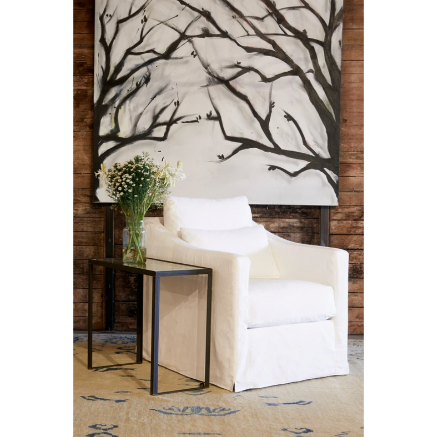 The Rebecca by Cisco Brothers has a stunning silhouette draped in a graceful slip skirt with a neat kick-pleat detail. With a lumbar pillow for extra comfort, this tranquil chair will bring relaxation and ease into your home. Photographed in Denim White. 