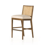 Mixed materials refresh retro stool seating. Light-toasted nettlewood frames a textural inlay of natural cane for a clean, monochromatic look, with a light, linen-blend seat of high-performance fabric brings smart sensibility to bar-style seating. Amethyst Home provides interior design, new home construction design consulting, vintage area rugs, and lighting in the Alpharetta metro area.