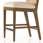Mixed materials refresh retro stool seating. Light-toasted nettlewood frames a textural inlay of natural cane for a clean, monochromatic look, with a light, linen-blend seat of high-performance fabric brings smart sensibility to bar-style seating. Amethyst Home provides interior design, new home construction design consulting, vintage area rugs, and lighting in the Calabasas metro area.