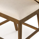 Mixed materials refresh retro stool seating. Light-toasted nettlewood frames a textural inlay of natural cane for a clean, monochromatic look, with a light, linen-blend seat of high-performance fabric brings smart sensibility to bar-style seating. Amethyst Home provides interior design, new home construction design consulting, vintage area rugs, and lighting in the Omaha metro area.