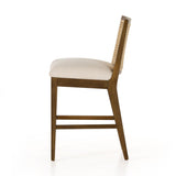 Mixed materials refresh retro stool seating. Light-toasted nettlewood frames a textural inlay of natural cane for a clean, monochromatic look, with a light, linen-blend seat of high-performance fabric brings smart sensibility to bar-style seating. Amethyst Home provides interior design, new home construction design consulting, vintage area rugs, and lighting in the San Diego metro area.