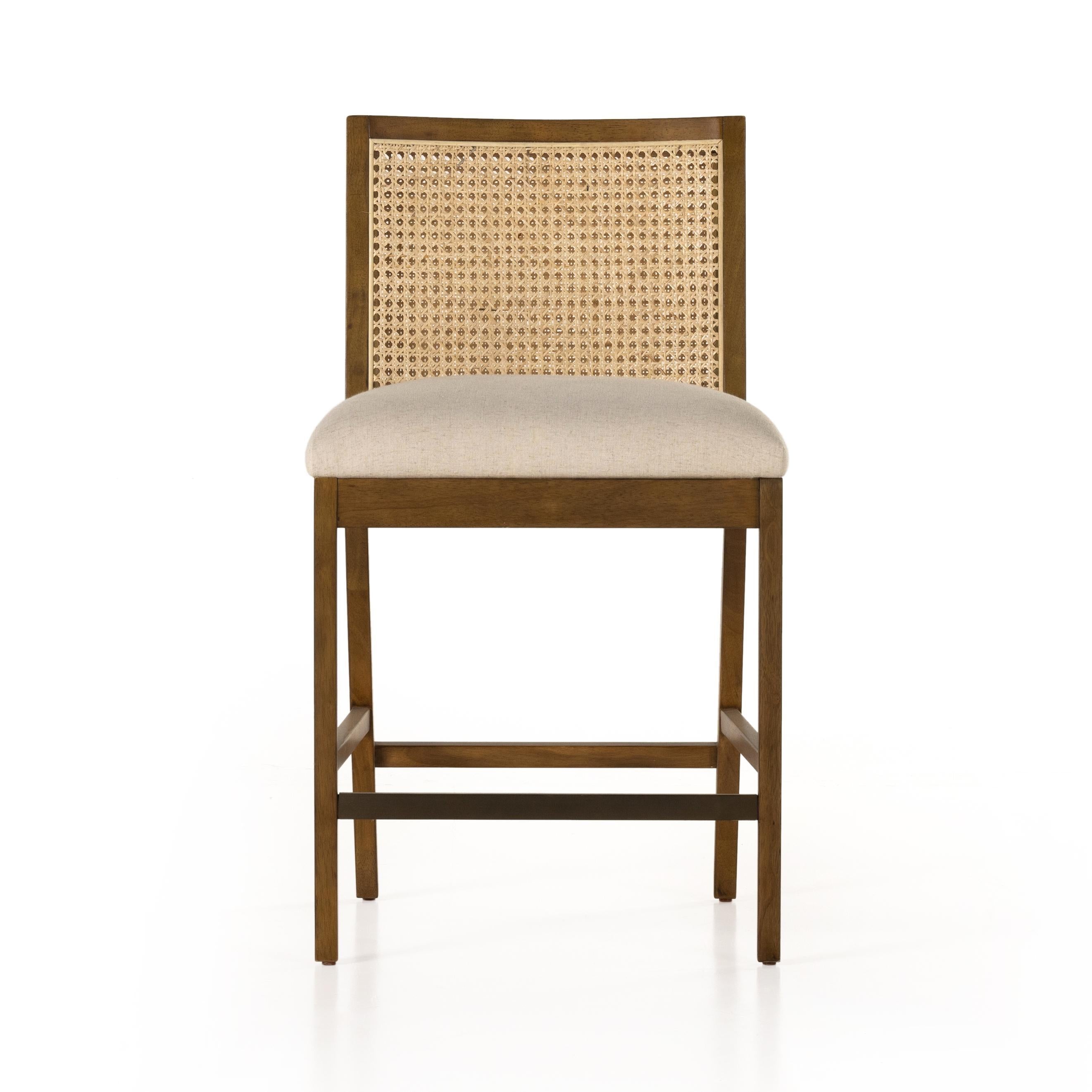 Mixed materials refresh retro stool seating. Light-toasted nettlewood frames a textural inlay of natural cane for a clean, monochromatic look, with a light, linen-blend seat of high-performance fabric brings smart sensibility to bar-style seating. Amethyst Home provides interior design, new home construction design consulting, vintage area rugs, and lighting in the Seattle metro area.