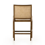 Mixed materials refresh retro stool seating. Light-toasted nettlewood frames a textural inlay of natural cane for a clean, monochromatic look, with a light, linen-blend seat of high-performance fabric brings smart sensibility to bar-style seating. Amethyst Home provides interior design, new home construction design consulting, vintage area rugs, and lighting in the Tampa metro area.