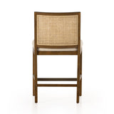 Mixed materials refresh retro stool seating. Light-toasted nettlewood frames a textural inlay of natural cane for a clean, monochromatic look, with a light, linen-blend seat of high-performance fabric brings smart sensibility to bar-style seating. Amethyst Home provides interior design, new home construction design consulting, vintage area rugs, and lighting in the Tampa metro area.