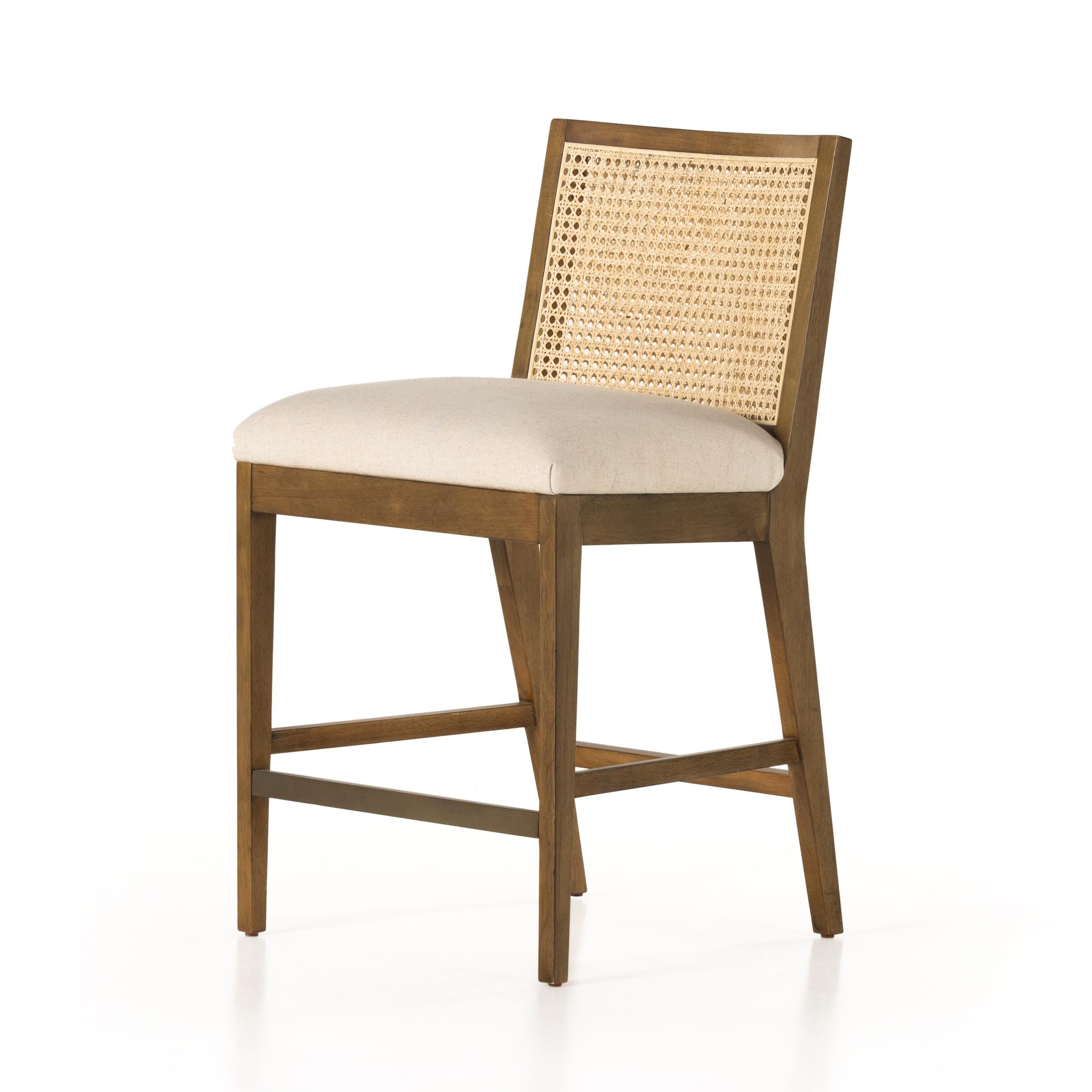 Mixed materials refresh retro stool seating. Light-toasted nettlewood frames a textural inlay of natural cane for a clean, monochromatic look, with a light, linen-blend seat of high-performance fabric brings smart sensibility to bar-style seating. Amethyst Home provides interior design, new home construction design consulting, vintage area rugs, and lighting in the Winter Garden metro area.