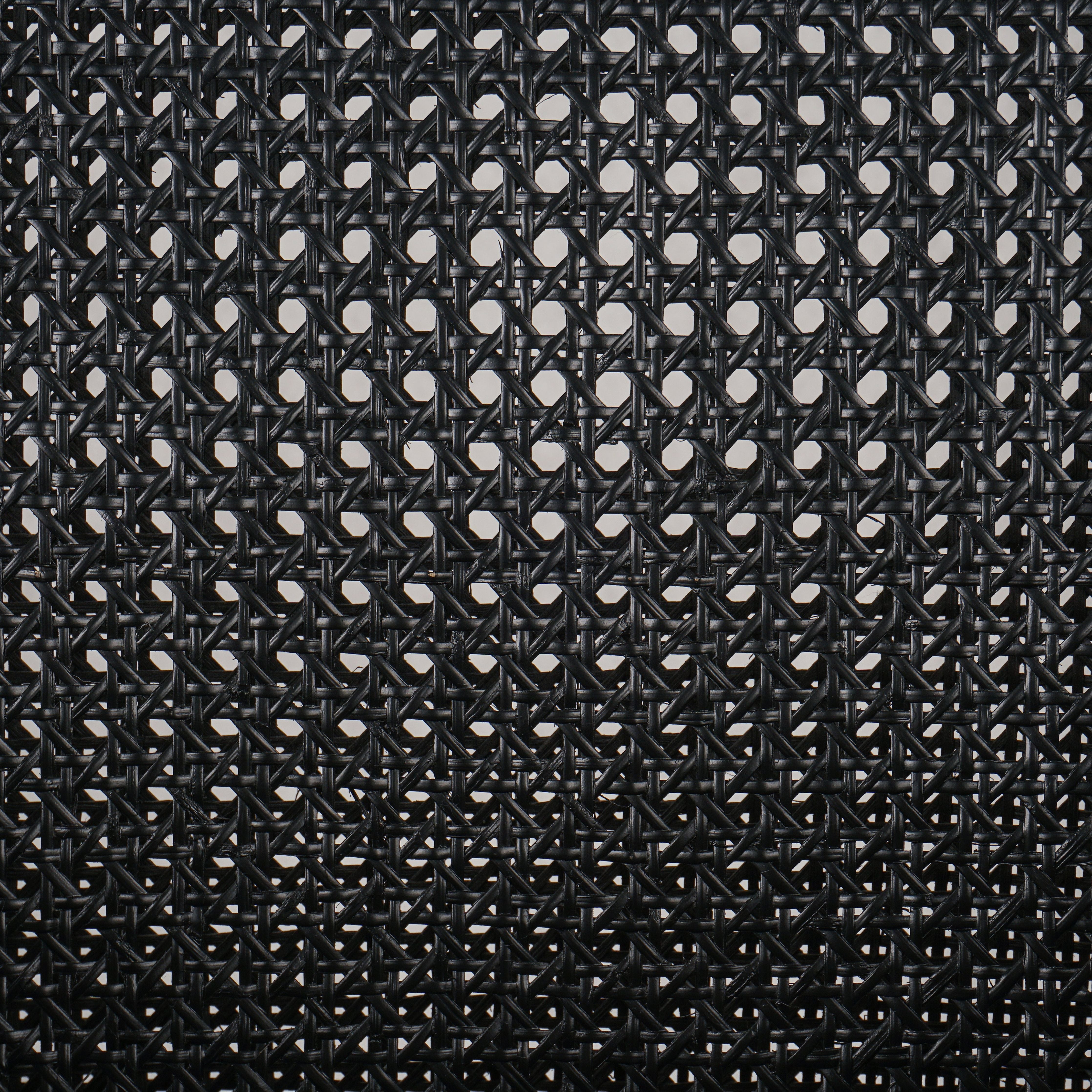 Ebony-brushed parawood frames a textural cane inlay, with top-grain leather seating in a chic black. Amethyst Home provides interior design, new construction, custom furniture, and area rugs in the Seattle metro area.