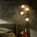 Featuring Armstrong Burnished Brass Opal Matte Glass 4 R Sconce by Four Hands at Amethyst Home. Matte glass spheres seem to extend and reach across smooth brass rods. Each globe is individually blown, shaped and sculpted by hand through a one-hour process. Matte globes are specially manufactured to evenly diffuse light. Brass and glass are 98% recyclable. . Amethyst Home provides interior design, new home construction design consulting, vintage area rugs, and lighting in the Washington metro area.