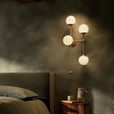 Featuring Armstrong Burnished Brass Opal Matte Glass 4 R Sconce by Four Hands at Amethyst Home. Matte glass spheres seem to extend and reach across smooth brass rods. Each globe is individually blown, shaped and sculpted by hand through a one-hour process. Matte globes are specially manufactured to evenly diffuse light. Brass and glass are 98% recyclable. . Amethyst Home provides interior design, new home construction design consulting, vintage area rugs, and lighting in the Washington metro area.
