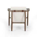Featuring Arnett Chair by Four Hands at Amethyst Home. Textural cream boucle seating offers a sumptuous sit, with complementary wire-brushed parawood framing forming a slim U shape. Two posterior top-grain leather straps add a stylish finishing touch. Performance fabrics are specially created to withstand spills, stains, high traffic and wear, ensuring long-term comfort and unmatc. Amethyst Home provides interior design, new construction, custom furniture and area rugs in the Des Moines metro area