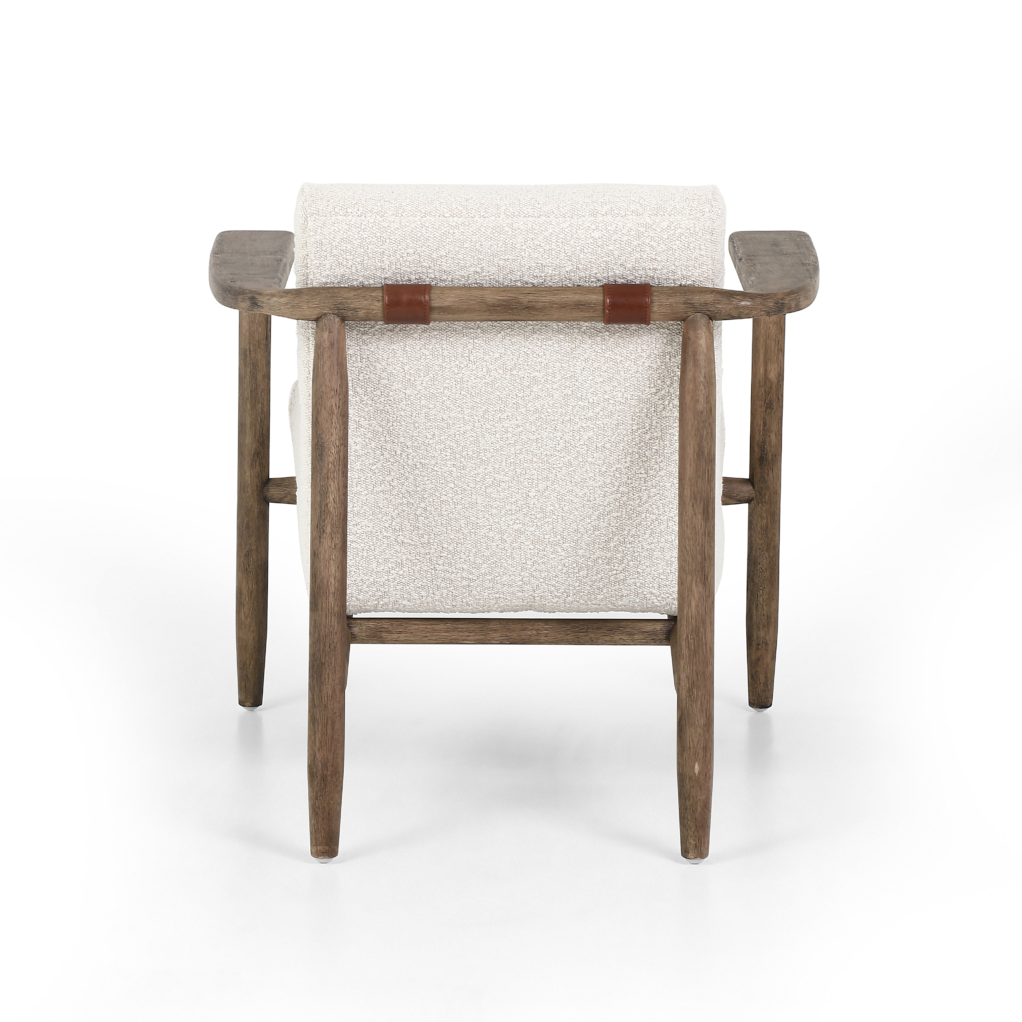 Featuring Arnett Chair by Four Hands at Amethyst Home. Textural cream boucle seating offers a sumptuous sit, with complementary wire-brushed parawood framing forming a slim U shape. Two posterior top-grain leather straps add a stylish finishing touch. Performance fabrics are specially created to withstand spills, stains, high traffic and wear, ensuring long-term comfort and unmatc. Amethyst Home provides interior design, new construction, custom furniture and area rugs in the Des Moines metro area