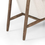 Featuring Arnett Chair by Four Hands at Amethyst Home. Textural cream boucle seating offers a sumptuous sit, with complementary wire-brushed parawood framing forming a slim U shape. Two posterior top-grain leather straps add a stylish finishing touch. Performance fabrics are specially created to withstand spills, stains, high traffic and wear, ensuring long-term comfort and unmatc. Amethyst Home provides interior design, new construction, custom furniture and area rugs in the Des Moines metro area