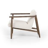 Featuring Arnett Chair by Four Hands at Amethyst Home. Textural cream boucle seating offers a sumptuous sit, with complementary wire-brushed parawood framing forming a slim U shape. Two posterior top-grain leather straps add a stylish finishing touch. Performance fabrics are specially created to withstand spills, stains, high traffic and wear, ensuring long-term comfort and unmatch. Amethyst Home provides interior design, new construction, custom furniture and area rugs in the Park City metro area