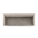 A dramatically channeled sofa with textural grey upholstery offers a clean look inspired by modern menswear. Amethyst Home provides interior design, new construction, custom furniture, and area rugs in the Charlotte metro area.