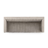 A dramatically channeled sofa with textural grey upholstery offers a clean look inspired by modern menswear. Amethyst Home provides interior design, new construction, custom furniture, and area rugs in the Charlotte metro area.