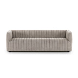 A dramatically channeled sofa with textural grey upholstery offers a clean look inspired by modern menswear. Amethyst Home provides interior design, new construction, custom furniture, and area rugs in the Los Angeles metro area.