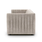 A dramatically channeled sofa with textural grey upholstery offers a clean look inspired by modern menswear. Amethyst Home provides interior design, new construction, custom furniture, and area rugs in the Newport Beach metro area.