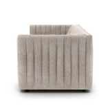 A dramatically channeled sofa with textural grey upholstery offers a clean look inspired by modern menswear. Amethyst Home provides interior design, new construction, custom furniture, and area rugs in the Newport Beach metro area.