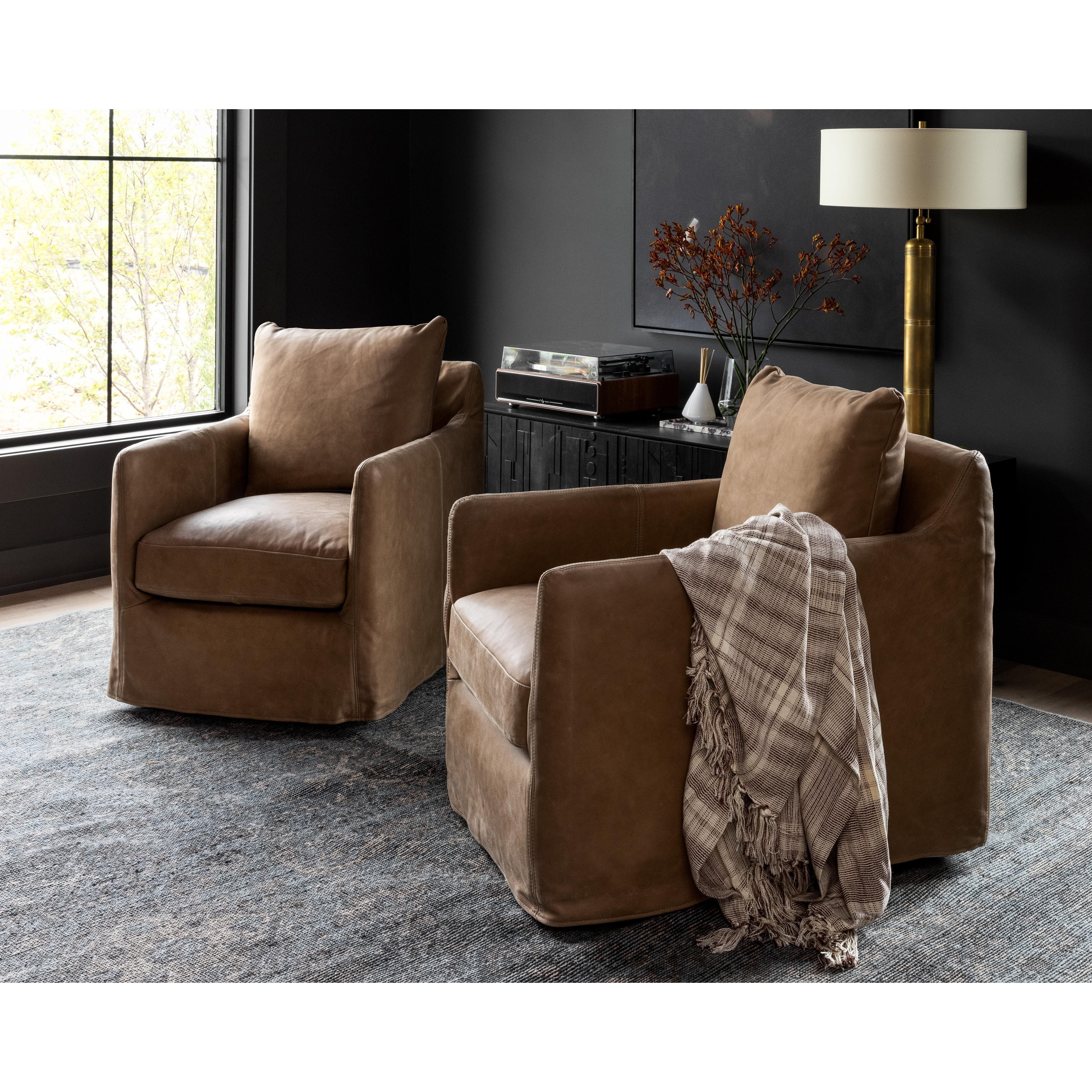 Introducing the Banks Palermo Drift Swivel Chair, the perfect addition to any moody room. Please expect natural distressing, adding character and charm to the chair. Pair it with Sherwin Williams Pewter Green walls and Surya rugs for a cohesive look. Whether you're in Nashville, Florida, or Utah, this chair will seamlessly blend with any modern coastal-inspired home design. Add the Banks Palermo Drift Swivel Chair to your living room or bedroom for a touch of sophistication and comfort.