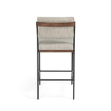 Simple and streamlined with fresh, thoughtful details. Slim, black-finished round stock iron suspends an almond-finished nettlewood deck, with a flannel-colored linen-blend seat and floating back with a rear wooden stretcher. Amethyst Home provides interior design services, furniture, rugs, and lighting in the Dallas metro area.