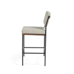Simple and streamlined with fresh, thoughtful details. Slim, black-finished round stock iron suspends an almond-finished nettlewood deck, with a flannel-colored linen-blend seat and floating back with a rear wooden stretcher. Amethyst Home provides interior design services, furniture, rugs, and lighting in the Seattle metro area.