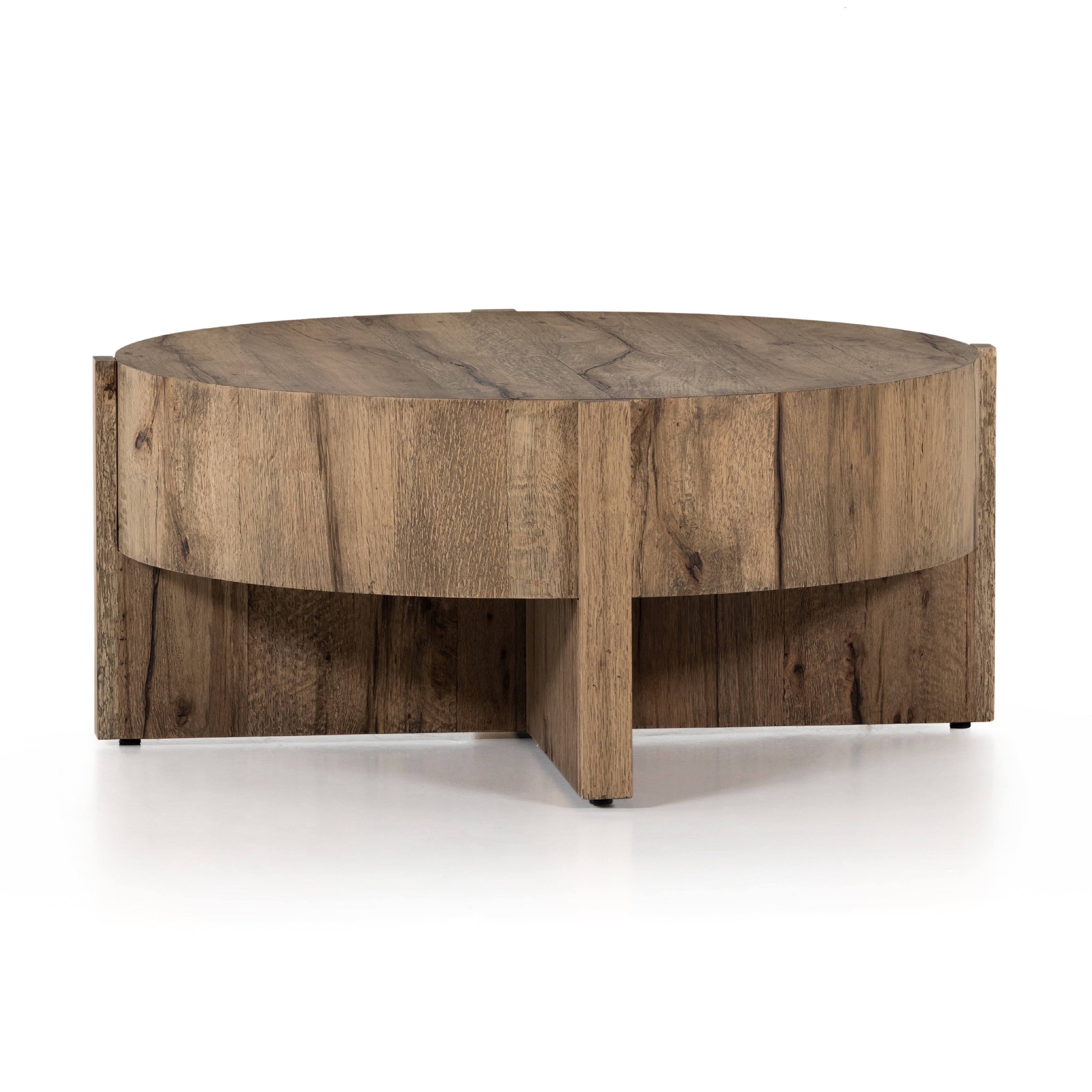 An organic-spirited statement piece. A drum-style coffee table of character-rich oak and veneers rests within a sculptural cradle base of matching rustic oak with beautiful highs and lows. Amethyst Home provides interior design, new construction, custom furniture, and area rugs in the Washington metro area.