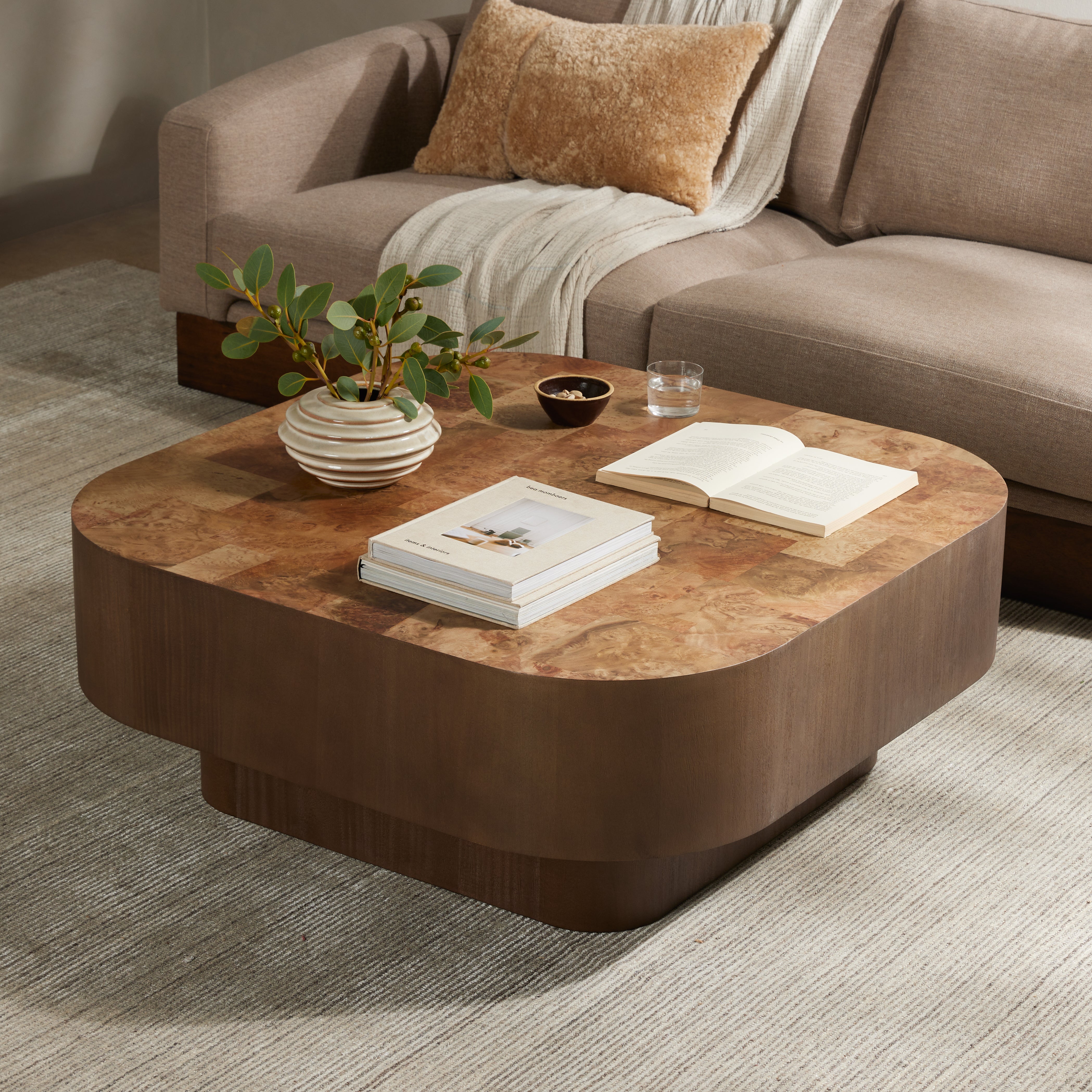 Featuring Blanco Warm Umber Burl Coffee Table by Four Hands at Amethyst Home. Made from warm-toned burl, a soft-squared tabletop features a patchwork pattern to bring novel movement to the modern coffee table. Veneer sides and an inset base complete a beautifully light look.Overall Dimensions: 40"W x 40"L x 16"H
Collection: WessonColors: Dark Mahogany ,Black Plywood ,Warm Umber BurlM. Amethyst Home provides interior design, new construction, custom furniture, and area rugs in the Omaha metro area.