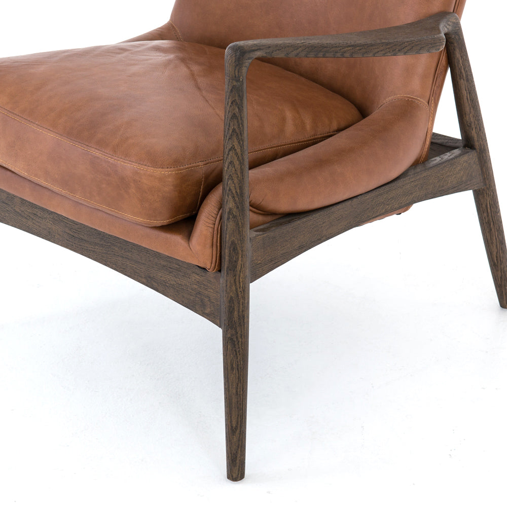 Dramatic arms and a deeper seat offer relaxation with mid-century modern sophistication. Sculpted nettlewood frame adds an architectural feel to brandy top-grain leather. Amethyst Home provides interior design, new construction, custom furniture, and area rugs in the Austin metro area.