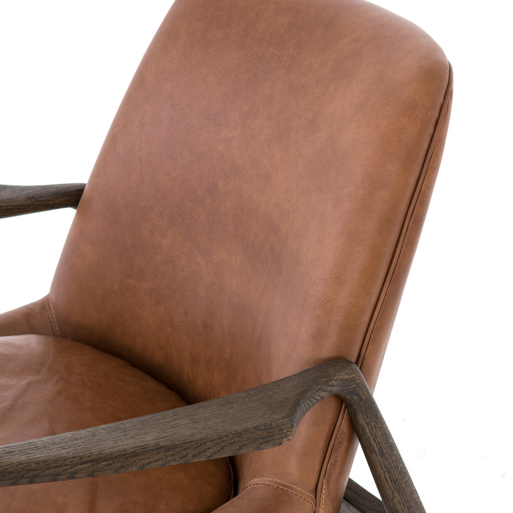 Dramatic arms and a deeper seat offer relaxation with mid-century modern sophistication. Sculpted nettlewood frame adds an architectural feel to brandy top-grain leather. Amethyst Home provides interior design, new construction, custom furniture, and area rugs in the Miami metro area.