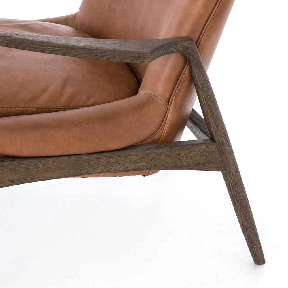 Dramatic arms and a deeper seat offer relaxation with mid-century modern sophistication. Sculpted nettlewood frame adds an architectural feel to brandy top-grain leather. Amethyst Home provides interior design, new construction, custom furniture, and area rugs in the Scottsdale metro area.
