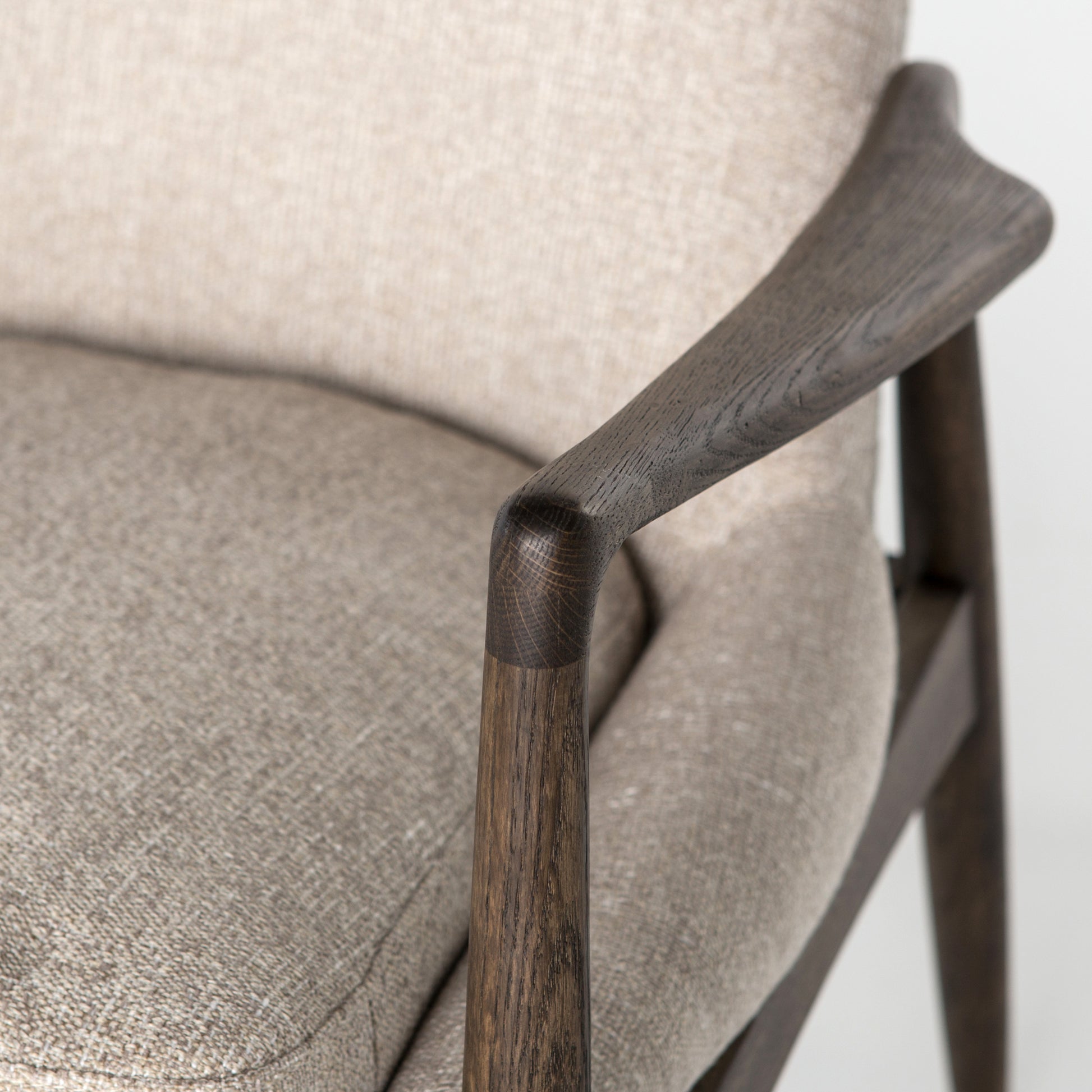 Dramatic arms and a deeper seat offer relaxation with mid-century modern sophistication. Sculpted frame adds an architectural feel to light camel upholstery. Amethyst Home provides interior design, new construction, custom furniture, and area rugs in the Houston metro area.
