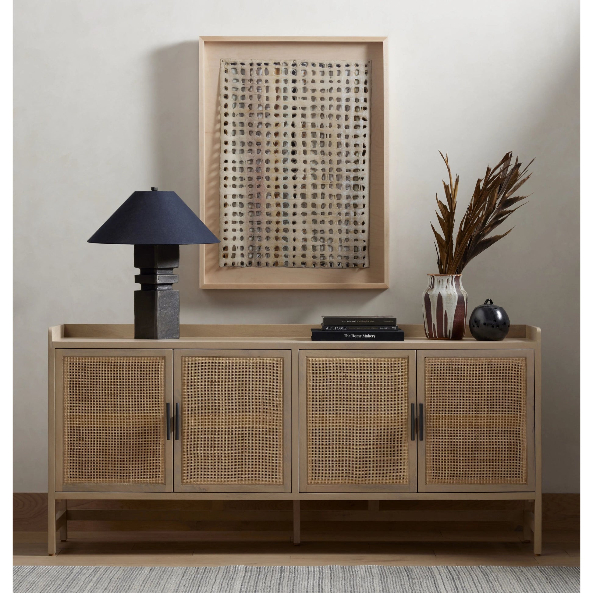 Monochromatic with a textural twist. Natural mango frames woven cane fronts, with black iron hardware for subtle contrast. Inside, spacious shelving awaits storage of dinnerware and more Amethyst Home provides interior design, new home construction design consulting, vintage area rugs, and lighting in the Los Angeles metro area.
