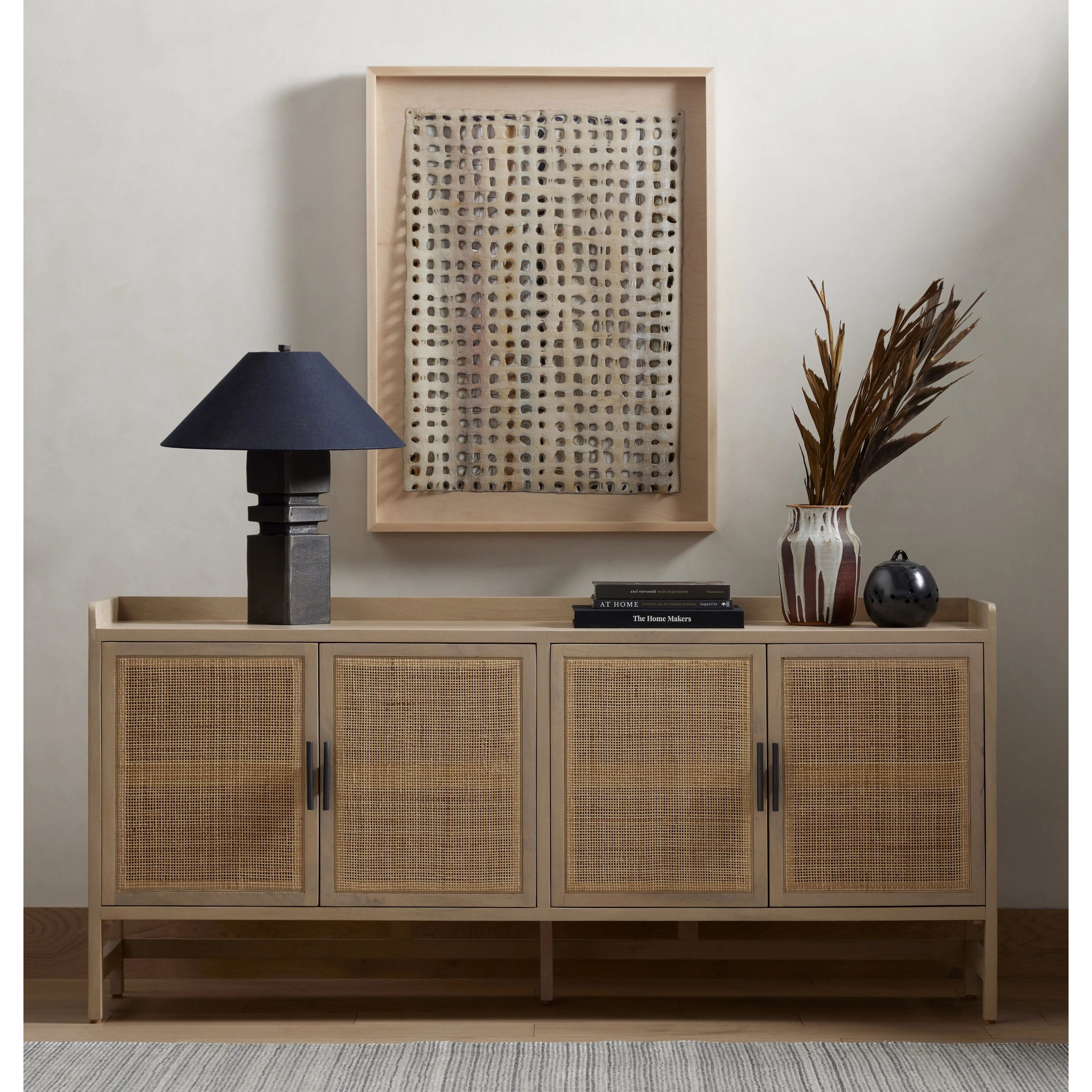 Monochromatic with a textural twist. Natural mango frames woven cane fronts, with black iron hardware for subtle contrast. Inside, spacious shelving awaits storage of dinnerware and more Amethyst Home provides interior design, new home construction design consulting, vintage area rugs, and lighting in the Los Angeles metro area.