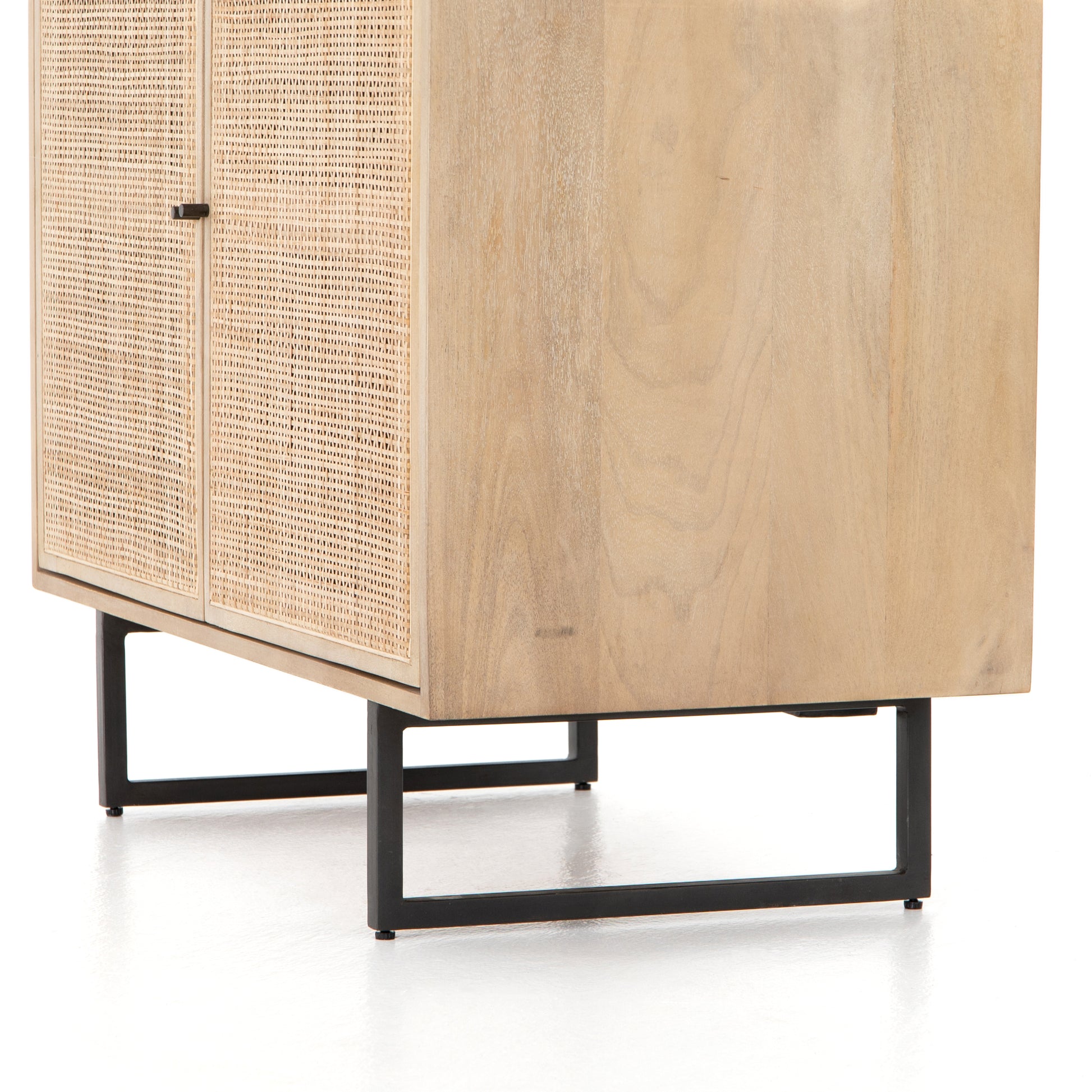 Mid-century style with an organic twist. Surrounded by mango casing, light cane weaves for a fresh look with natural depth. Angular gunmetal-finished iron legs offer an intriguing contrast of texture and tone. Perfect solo or paired up. Amethyst Home provides interior design services, furniture, rugs, and lighting in the Miami metro area.
