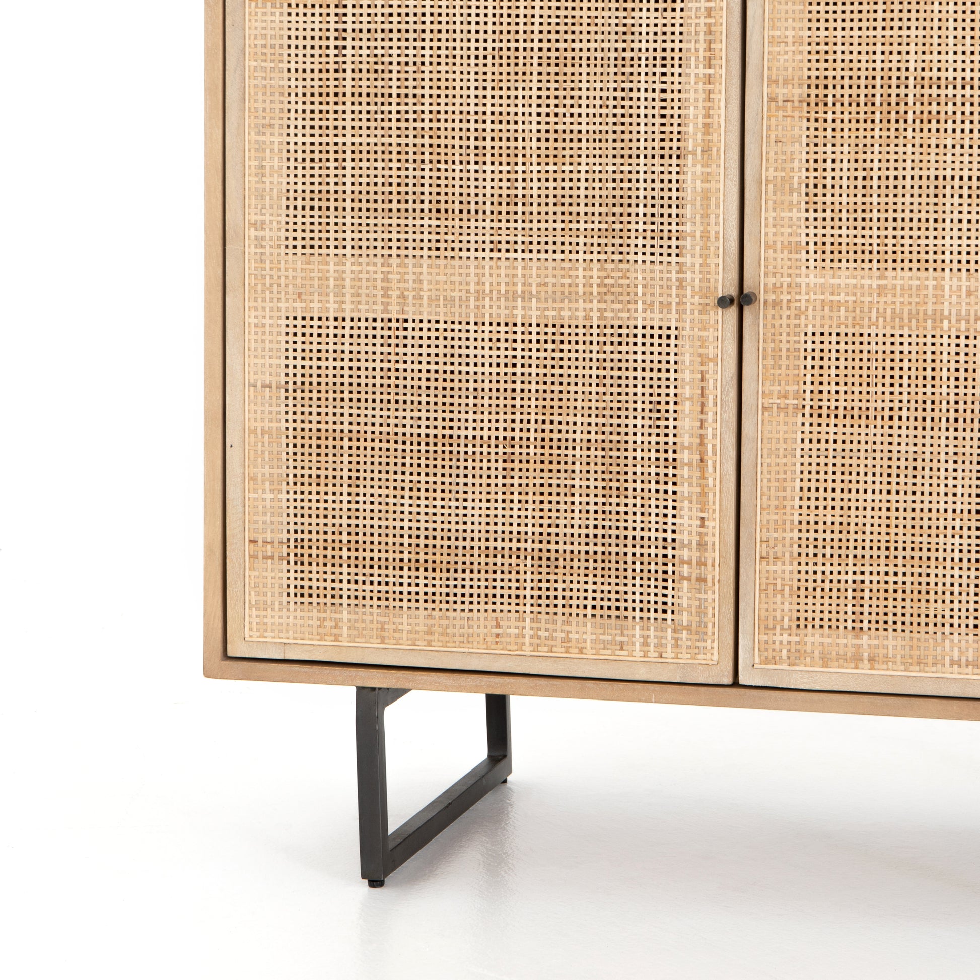Mid-century style with an organic twist. Surrounded by mango casing, light cane weaves for a fresh look with natural depth. Angular gunmetal-finished iron legs offer an intriguing contrast of texture and tone. Perfect solo or paired up. Amethyst Home provides interior design services, furniture, rugs, and lighting in the Seattle metro area.
