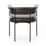 Featuring Carrie Sonoma Black Dining Chair by Four Hands at Amethyst Home. Airy and light with slim, black-finished iron framing, slate-colored performance boucle lends texture to a beautifully sculpted dining style featuring a yoke back and exterior fold detailing. Easy to clean and made from fully recyclable materials, Fiqa fabrics are machine-washable, . Amethyst Home provides interior design, new home construction design consulting, vintage area rugs, and lighting in the Des Moines metro area.