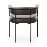 Featuring Carrie Sonoma Black Dining Chair by Four Hands at Amethyst Home. Airy and light with slim, black-finished iron framing, slate-colored performance boucle lends texture to a beautifully sculpted dining style featuring a yoke back and exterior fold detailing. Easy to clean and made from fully recyclable materials, Fiqa fabrics are machine-washable, . Amethyst Home provides interior design, new home construction design consulting, vintage area rugs, and lighting in the Des Moines metro area.