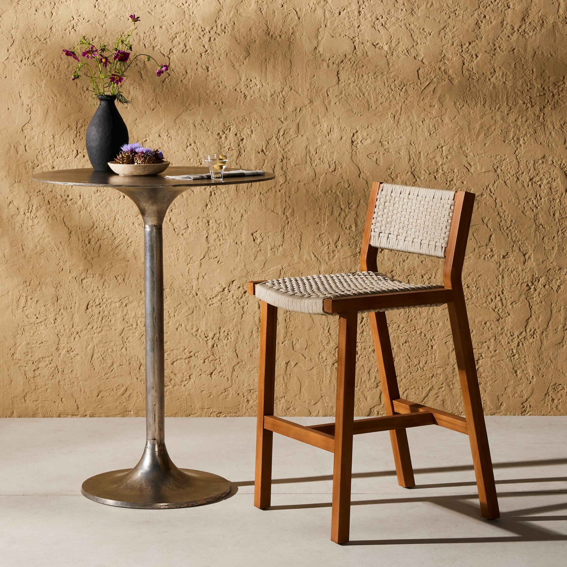 A textural take on outdoor bar styling, natural teak welcomes thick, handwoven rope seating in an inviting ivory. Safe for outdoor spaces. Cover or store indoors during inclement weather and when not in use. Amethyst Home provides interior design, new construction, custom furniture, and area rugs in the Dallas metro area.