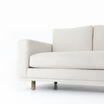 Performance-grade fabric brings surprising livability to a show-stopping silhouette. Pristinely tailored ivory upholstery exudes elegance, with clean track arms and loose feather-blend cushioning for total comfort. Cushions not reversible. Amethyst Home provides interior design, new construction, custom furniture, and area rugs in the Kansas City metro area.