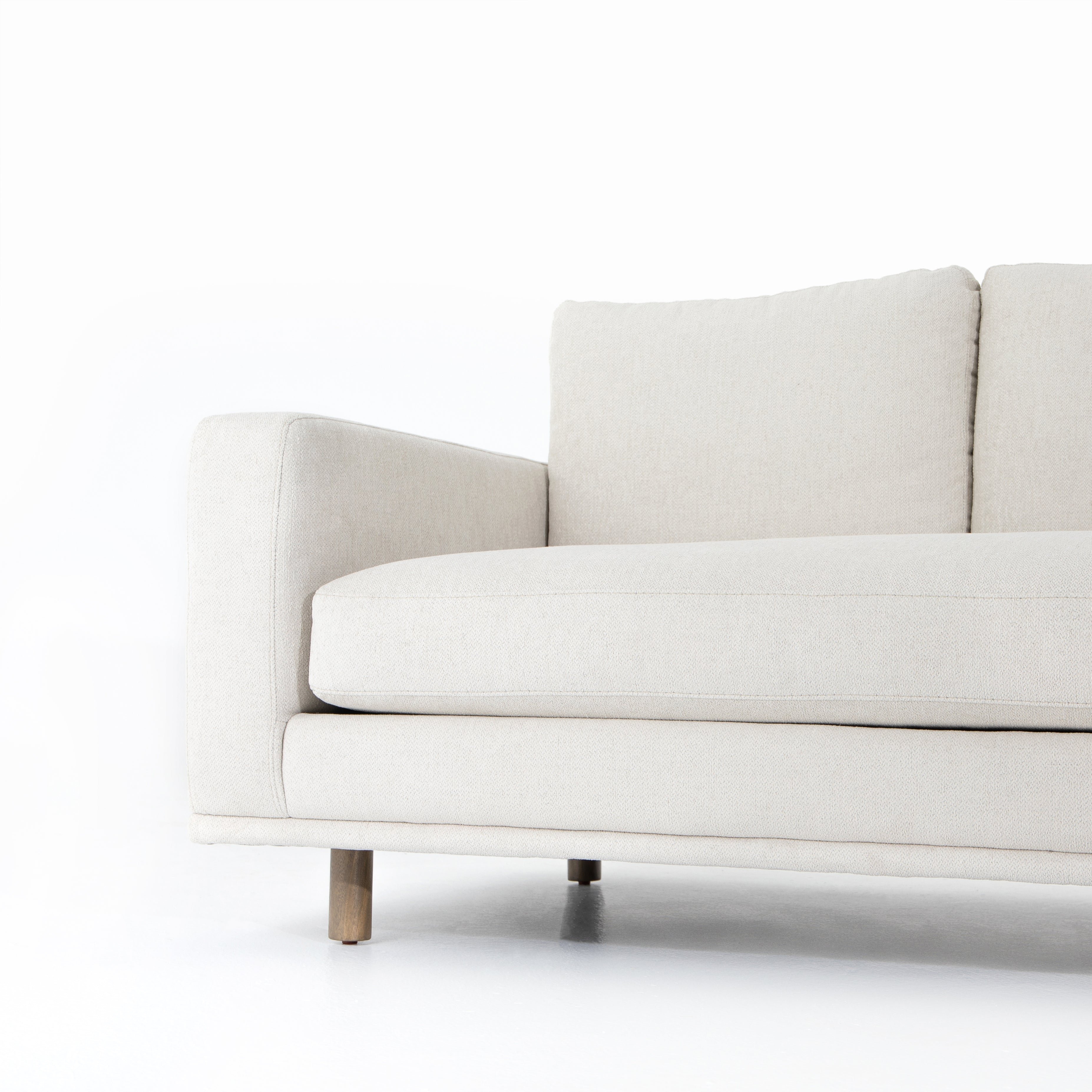 Performance-grade fabric brings surprising livability to a show-stopping silhouette. Pristinely tailored ivory upholstery exudes elegance, with clean track arms and loose feather-blend cushioning for total comfort. Cushions not reversible. Amethyst Home provides interior design, new construction, custom furniture, and area rugs in the Kansas City metro area.