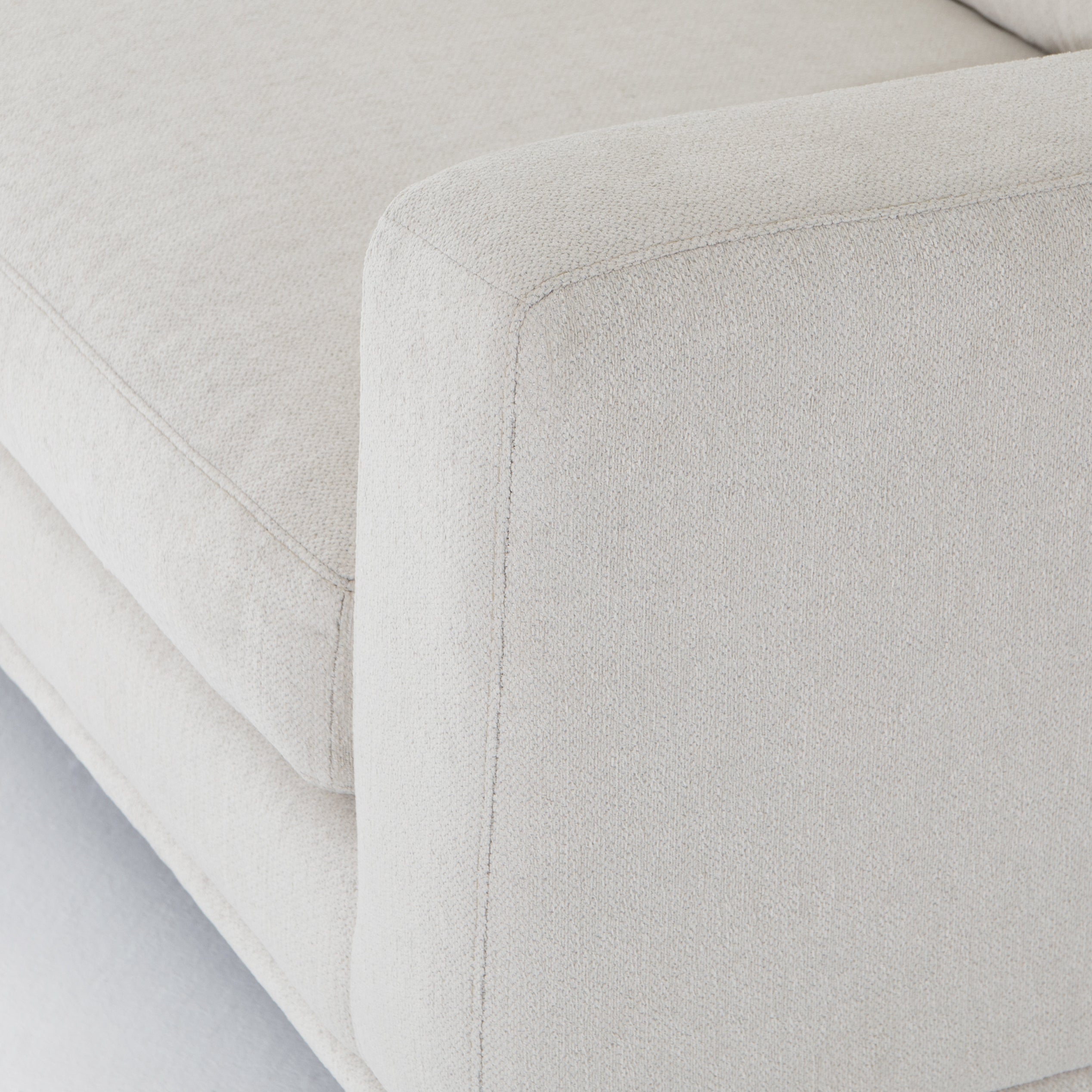 Performance-grade fabric brings surprising livability to a show-stopping silhouette. Pristinely tailored ivory upholstery exudes elegance, with clean track arms and loose feather-blend cushioning for total comfort. Cushions not reversible. Amethyst Home provides interior design, new construction, custom furniture, and area rugs in the Laguna Beach metro area.