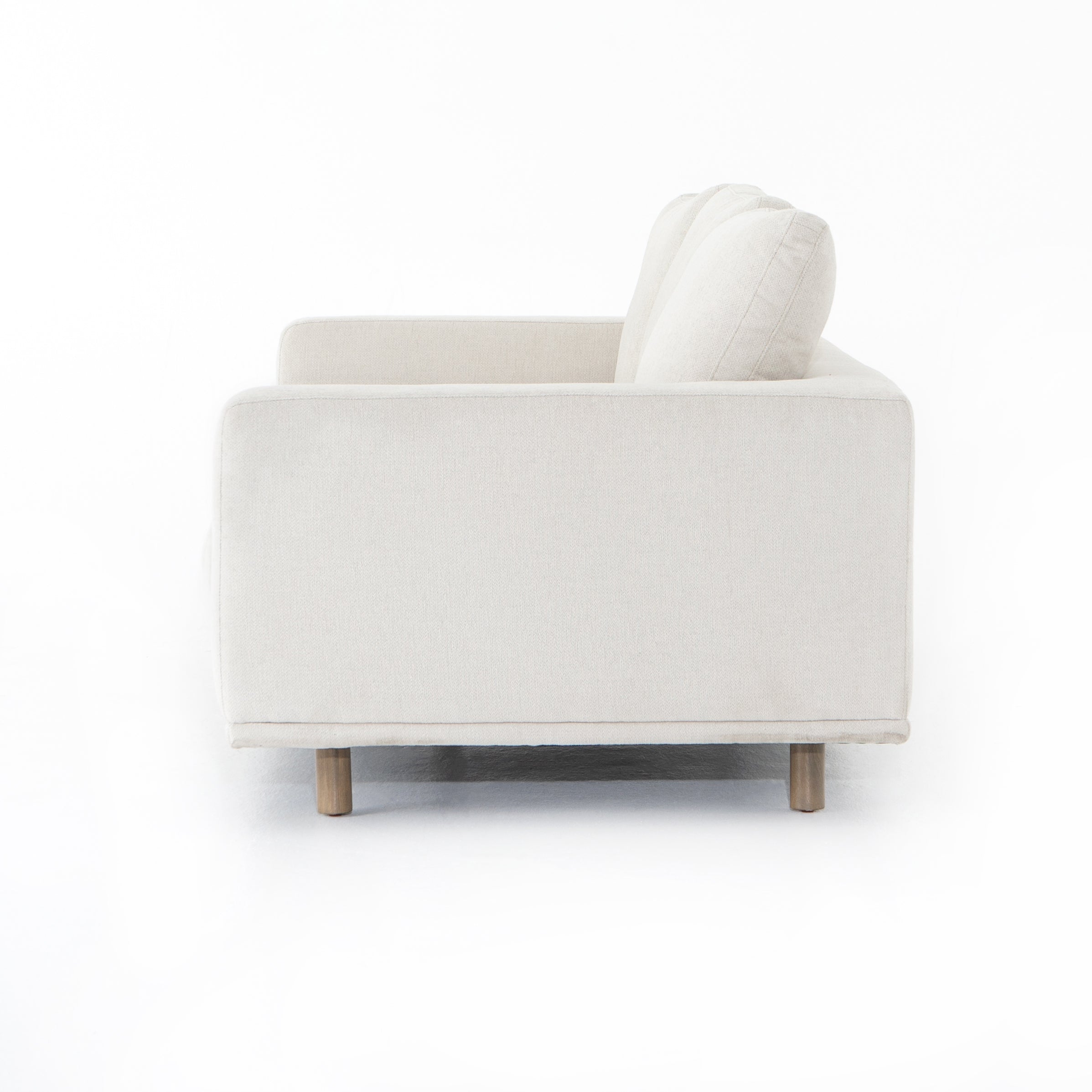 Performance-grade fabric brings surprising livability to a show-stopping silhouette. Pristinely tailored ivory upholstery exudes elegance, with clean track arms and loose feather-blend cushioning for total comfort. Cushions not reversible. Amethyst Home provides interior design, new construction, custom furniture, and area rugs in the Seattle metro area.