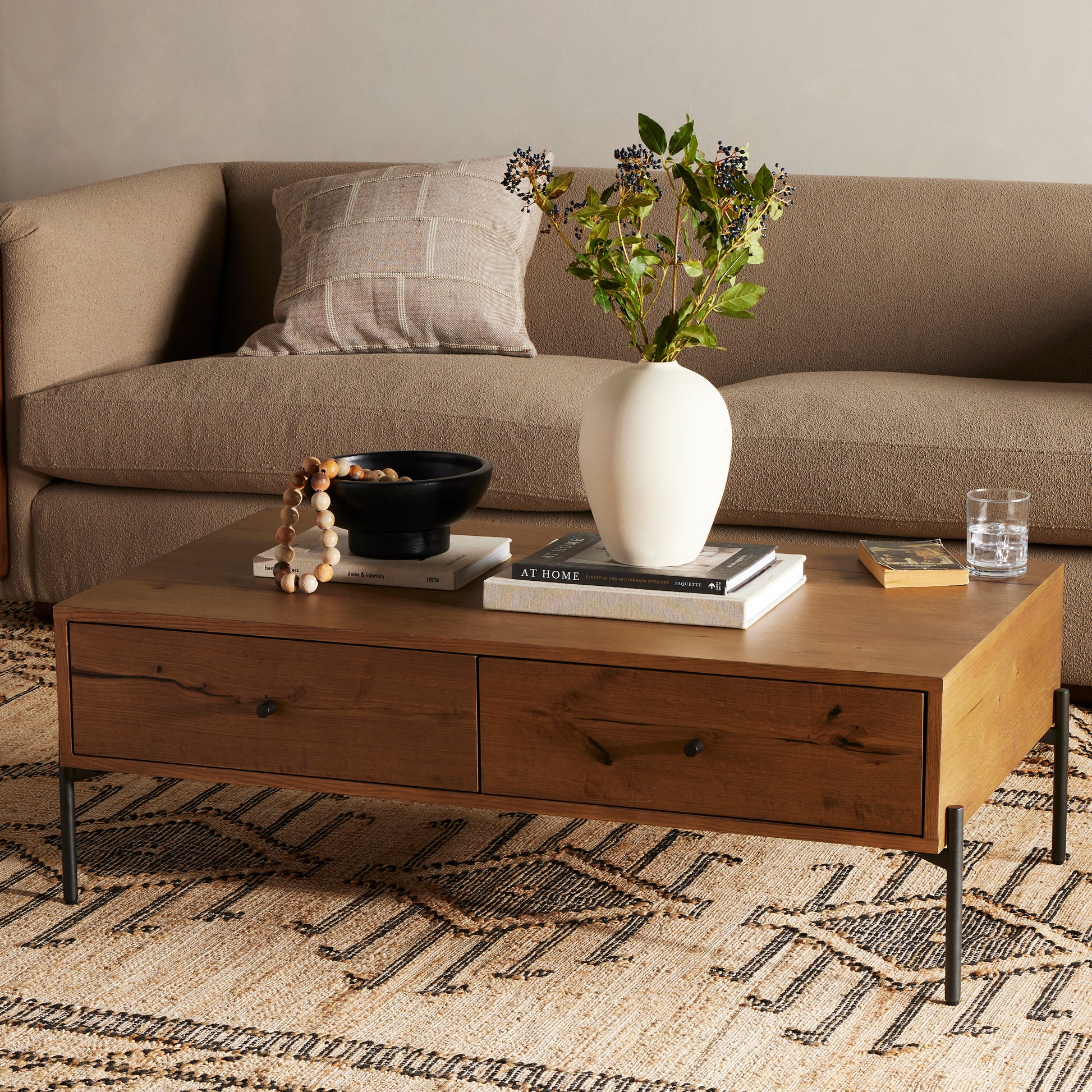 A slight cradle base of gunmetal-finished iron supports a clean-lined coffee table made from thick oak veneer, with dual drawers for extra storage space. For a rich, one-of-a-kind look, black resin fills woods' natural cracks and graining. A subtle variance of resin placement and amount is to be expected, and reflective of materials' character-rich roots. Amethyst Home provides interior design, new construction, custom furniture, and area rugs in the Miami metro area.