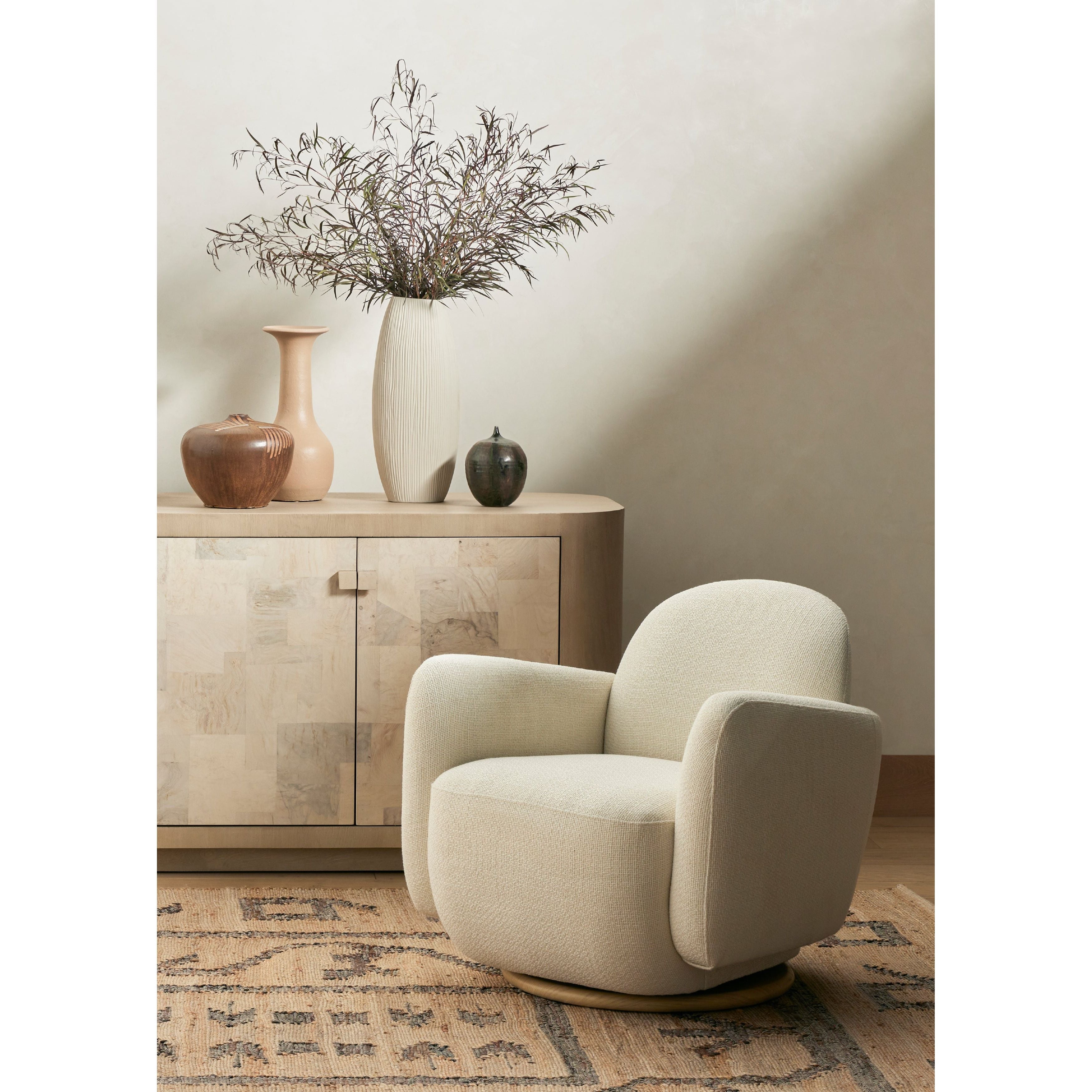 Featuring Enya Gibson White Swivel Chair by Four Hands at Amethyst Home. With soft volume and exaggerated curves, the Enya Gibson White Swivel Chair is upholstered with high-performance fabric atop a plinth-style swivel base. Performance fabrics are specially created to withstand spills, stains, high traffic and wear, ensuring long-term comfort and unmatched durability.
Overall Dimensions: . Amethyst Home provides interior design services, furniture, rugs, and lighting in the Charlotte metro area.