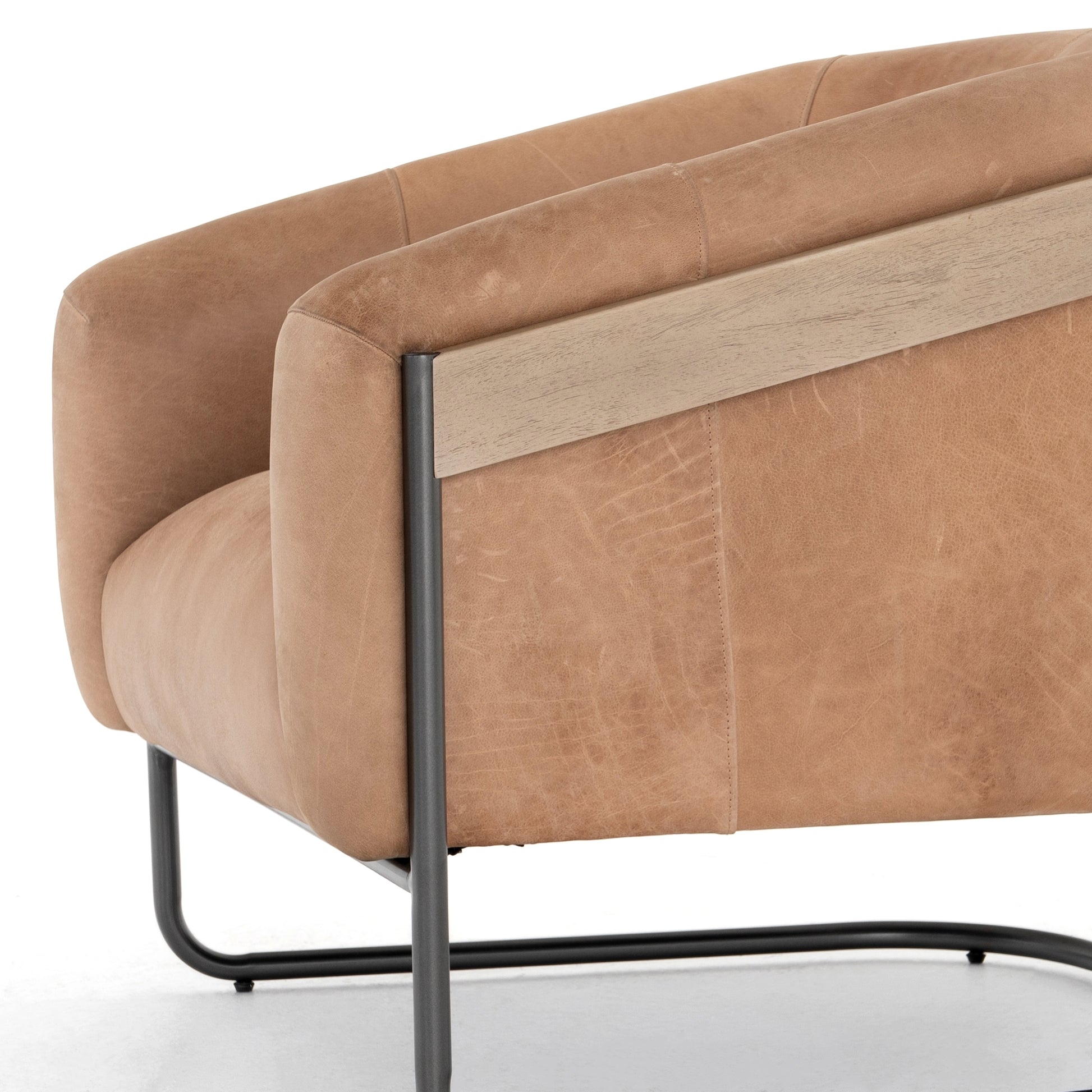 Deco-driven elegance. A fresh take on the traditional cigar chair, impeccably tailored tan top-grain leather forms a curvy U shape, with solid parawood detailing adding interest to gunmetal-finished iron framing. Amethyst Home provides interior design, new construction, custom furniture, and area rugs in the Monterey metro area.