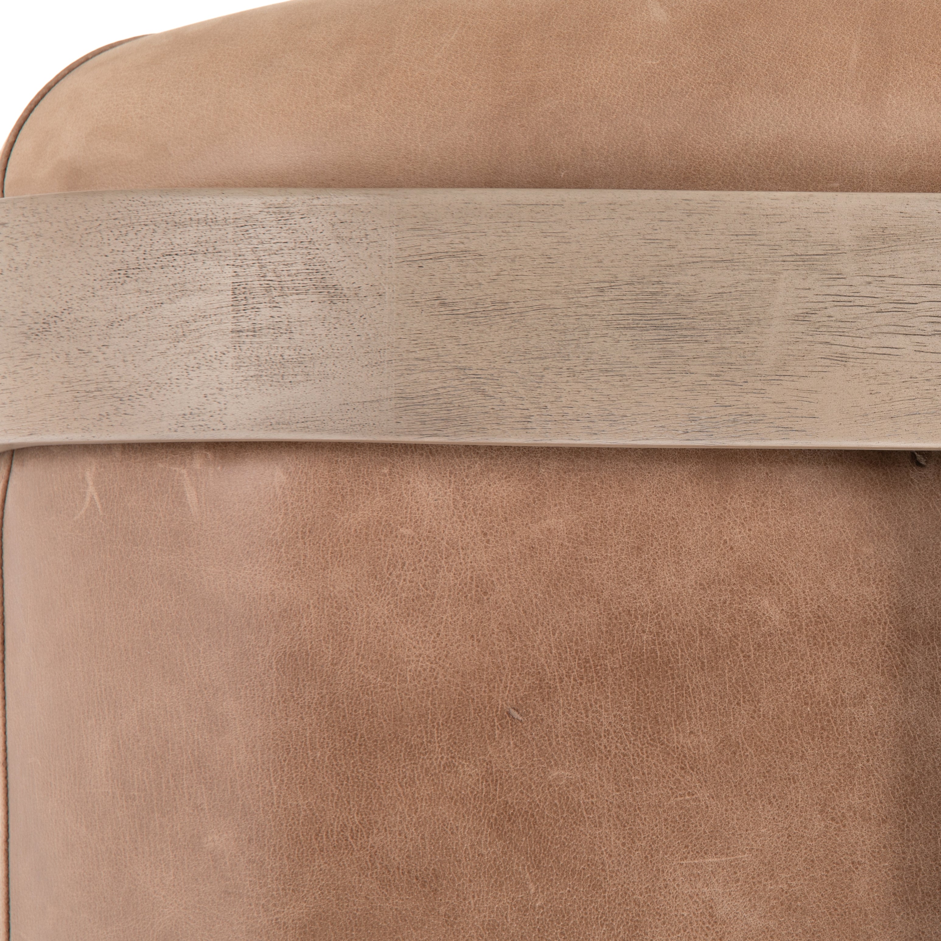 Deco-driven elegance. A fresh take on the traditional cigar chair, impeccably tailored tan top-grain leather forms a curvy U shape, with solid parawood detailing adding interest to gunmetal-finished iron framing. Amethyst Home provides interior design, new construction, custom furniture, and area rugs in the Omaha metro area.